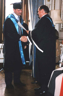 Photo of Andrey Zorin, left, receiving his MBA from Pro Vice-Chancellor for External Affairs and Business Development Professor David Miles.