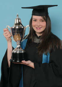 Photo of Susan Ruggles with the Andrew Yale Cup.