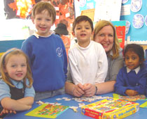 Photo of Diana Kill with pupils at Coombe Hill Infant School.