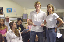 Photo of creative writing student Jonathan Willock, centre, and Dr Meg Jensen.