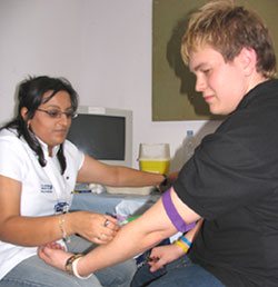 Student Chris Ford has his blood sample taken by Azra Iqbal from the Anthony Nolan Trust.