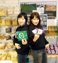 Korean students Kim Sujeong (left) and Chae Sooeun with Fairtrade goods in Kingston Universityâ€™s Studentsâ€™ Union shop. 