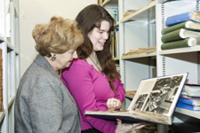 Ruth Leon and Kingston University archivist Katie Giles view a book from The Sheridan Morley Theatre Collection.