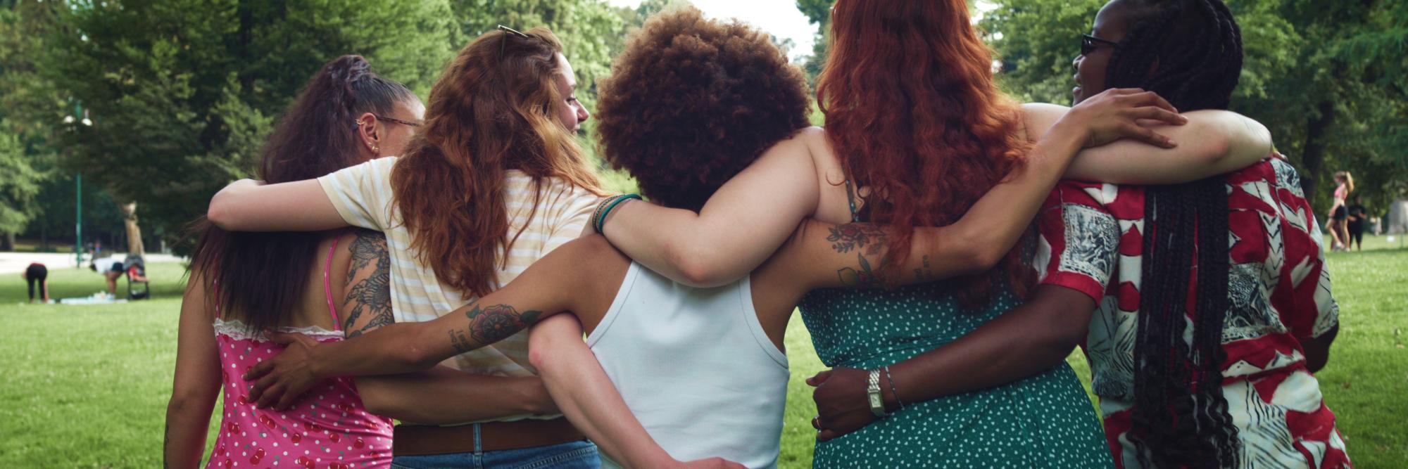 Five women arm in arm